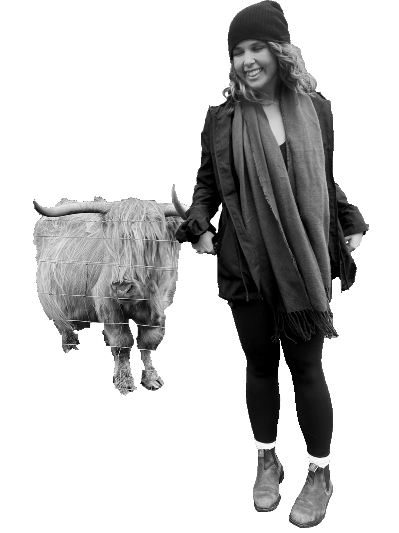 a picture of kaaren in front of a mountain with a highland cow